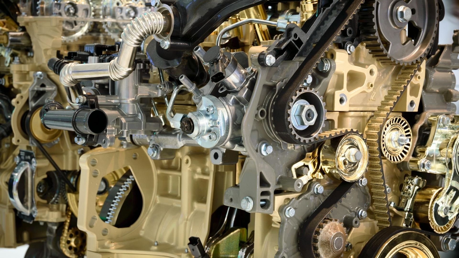 Close-up of internal combustion engine showing pistons, gears, and metal components